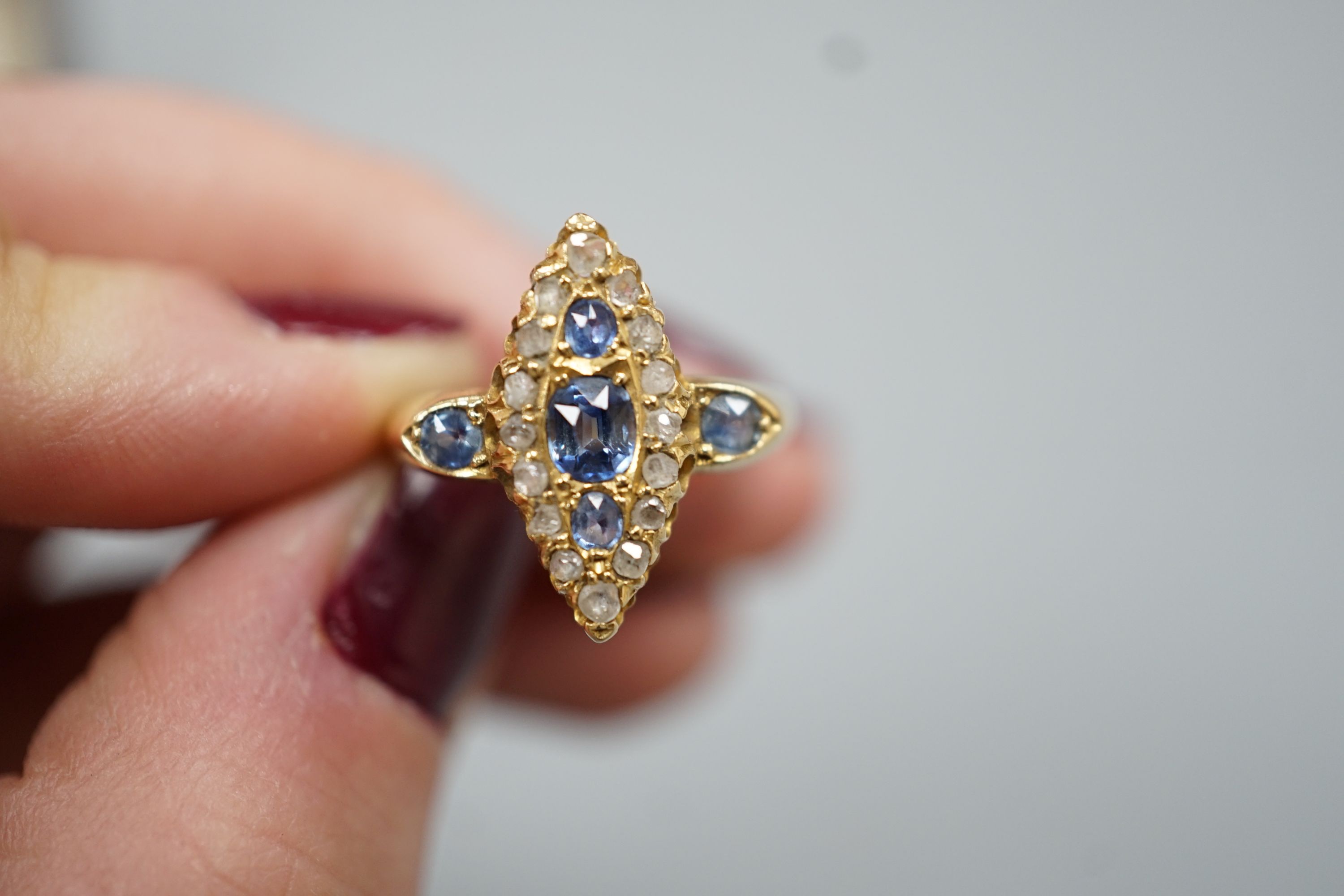 An Edwardian 18ct gold, sapphire and diamond set marquise set cluster ring, size K, gross weight 3.2 grams